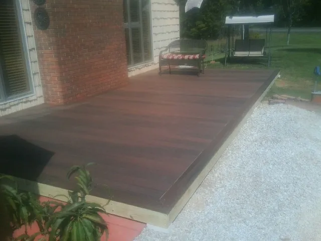 Freshly stained wood deck built against a brick home in Sylvester